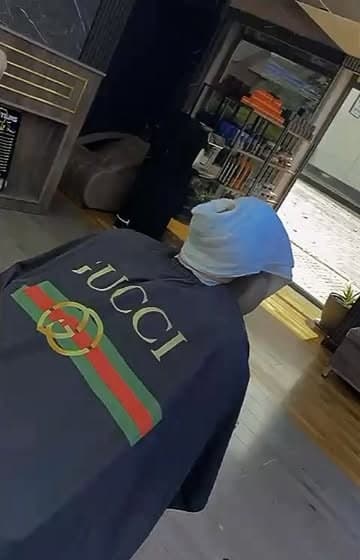 Client in the chair with a towel wrapped round their head inside Nwah Trims