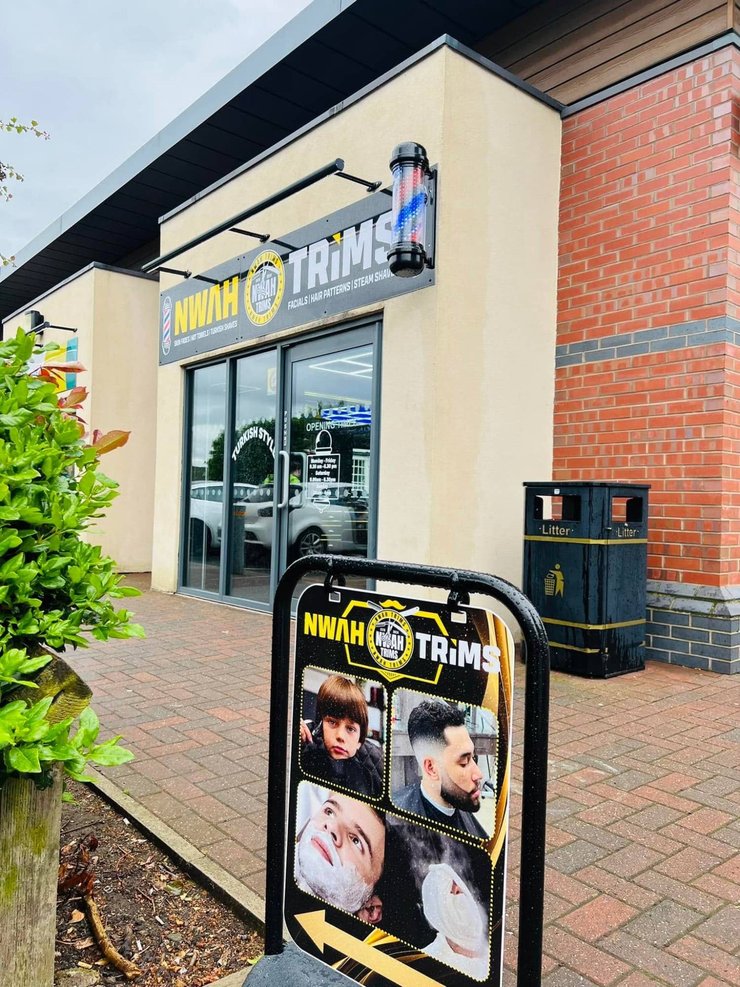 The Nwah Trims shopfront at Hadley District Centre, Telford, with its sign, barber pole and A-board outside